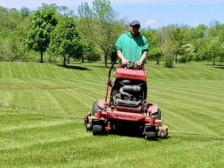 Ben working hard mowing a lawn